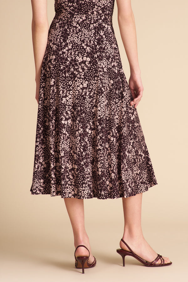 Woman wearing a floral dress on a beige background | Exclude