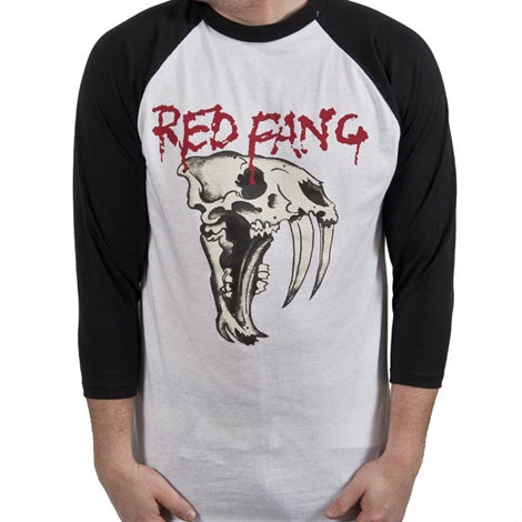 A person wears a Red Fang white and black raglan shirt featuring RED FANG in red, dripping letters above a large saber-toothed skull graphic.