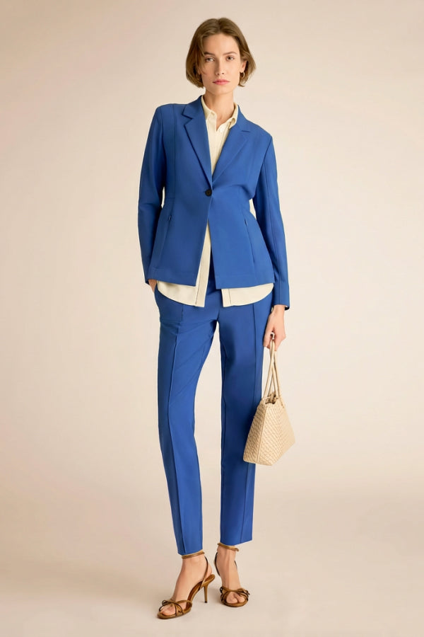 Woman wearing a blue suit with a beige background | Exclude | Grid Hover