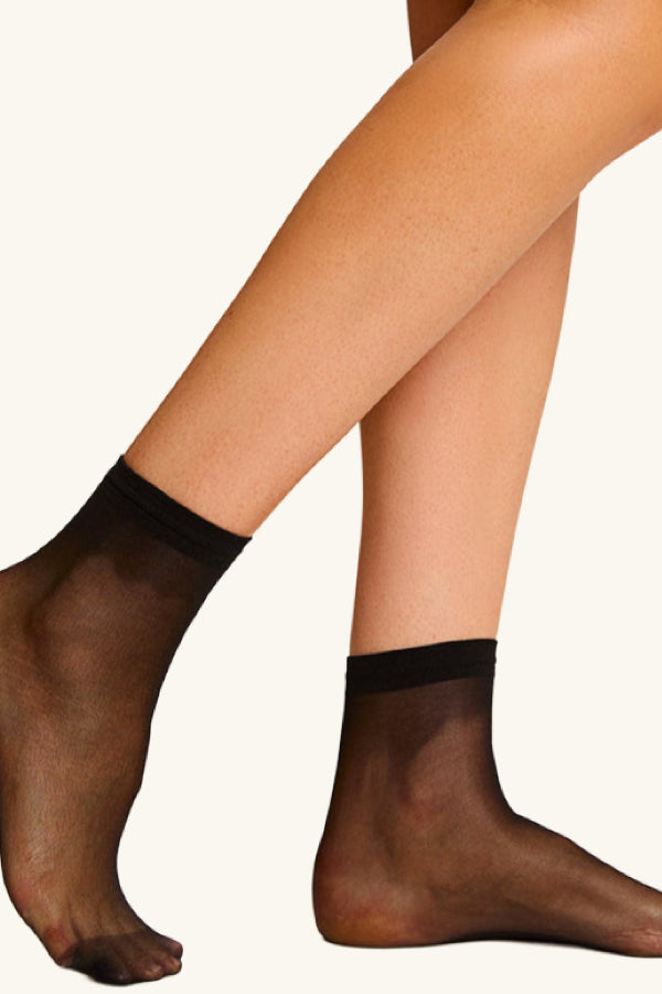 Black sheer socks worn by a person on a white background | ALT GRID | Exclude