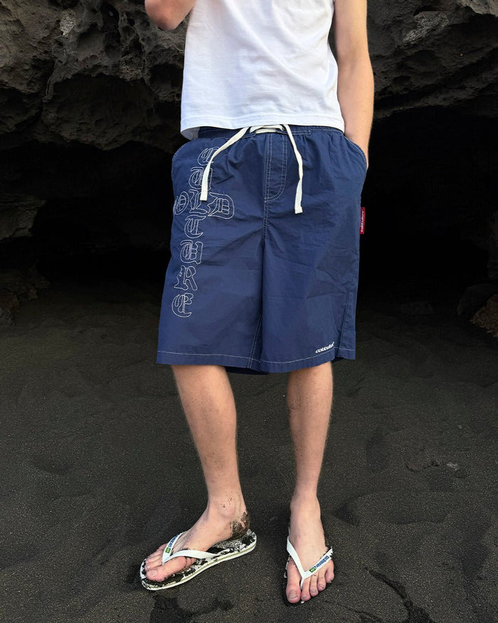 CROSSED SWIMSHORTS BLUE - navy gothic print swim shorts, worn detail - Cold Culture