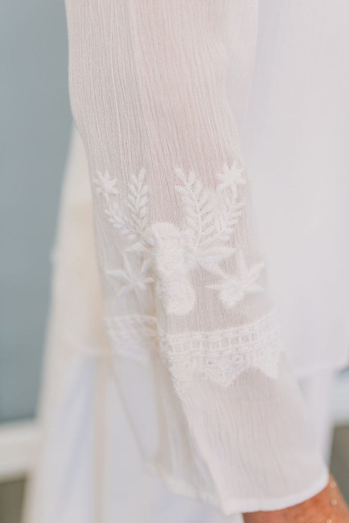 detail of embroidery on blouse sleeve