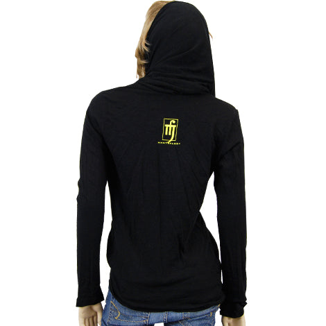 A person is seen from the back wearing a black Mantralogy hooded long-sleeve shirt with a small yellow and white logo centered on the upper back, paired with blue jeans.