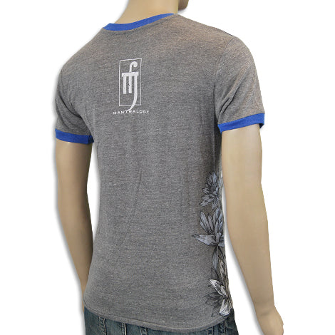 A mannequin is shown from behind wearing a fitted gray Mantralogy T-shirt with blue trim, a white graphic logo on the back, and a floral design near the bottom side.