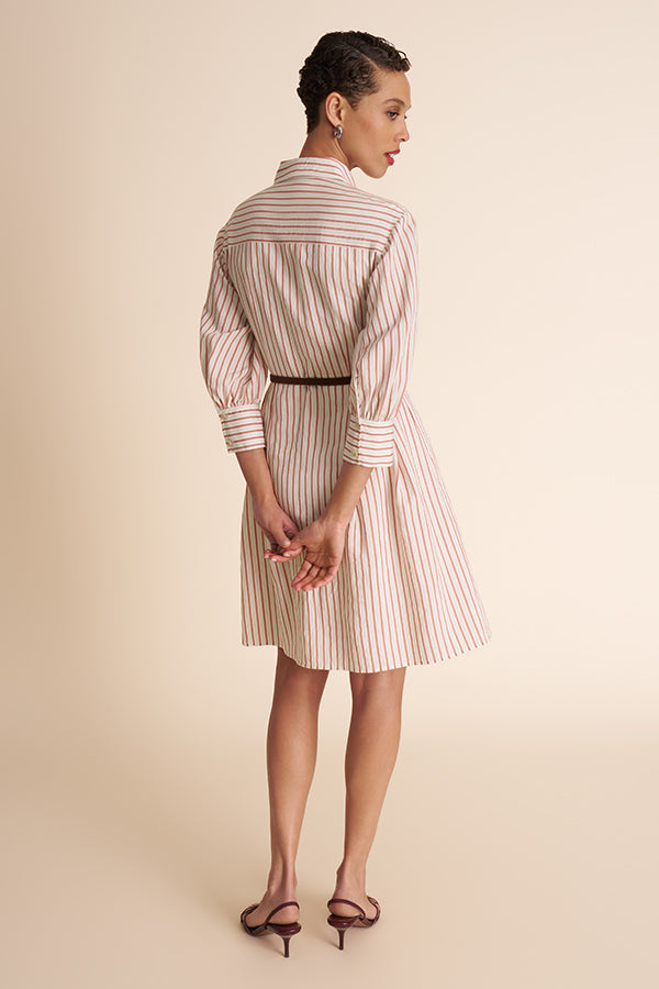Woman wearing a striped dress on a beige background | Exclude | Grid Hover