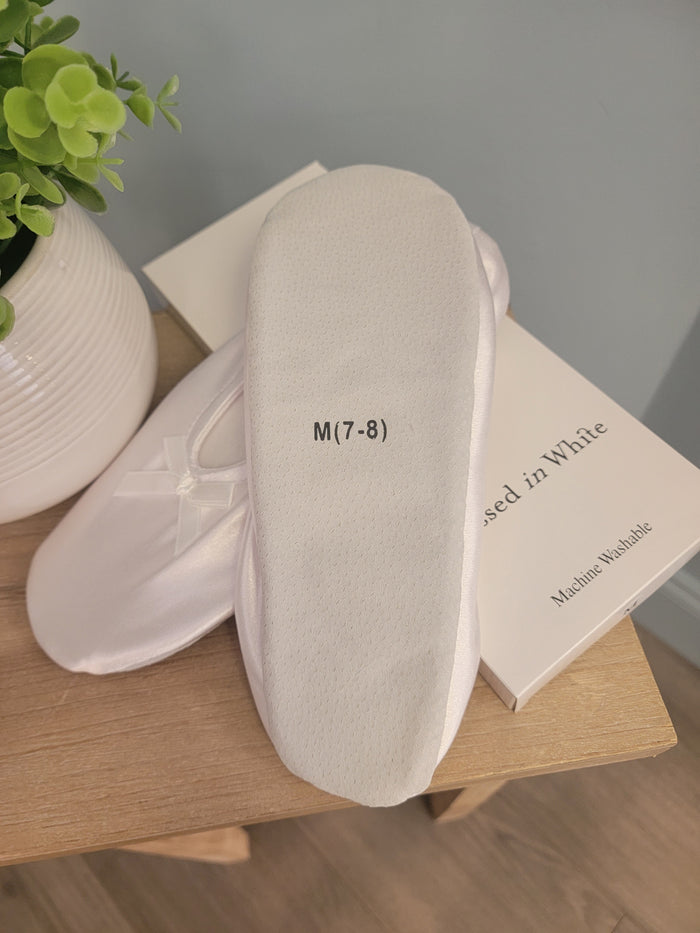 Bottom of white satin slippers.
