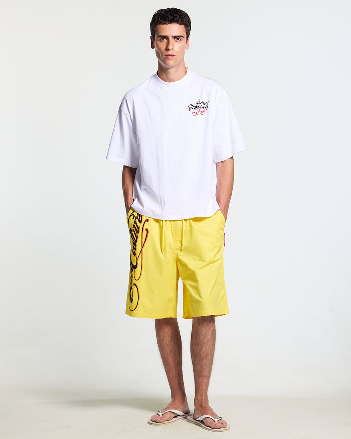 SCRIPT SWIMSHORTS YELLOW - yellow script print swim shorts, front view on male model - Cold Culture