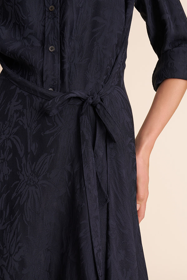 Navy blue dress with floral pattern and tie waist on a beige background | Exclude | Grid Hover
