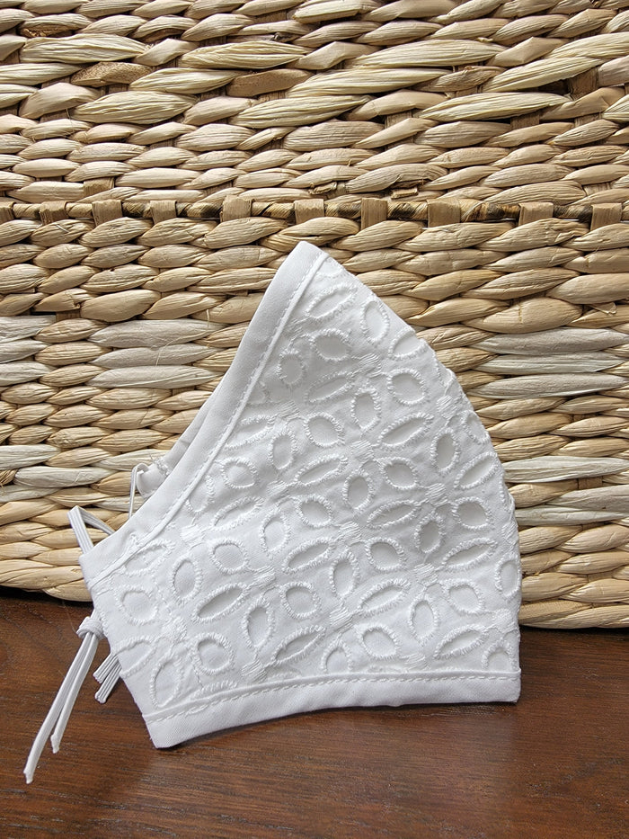 White face mask with eyelet lace overlay.