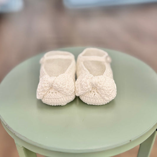 Crochet baby booties with crochet bow.