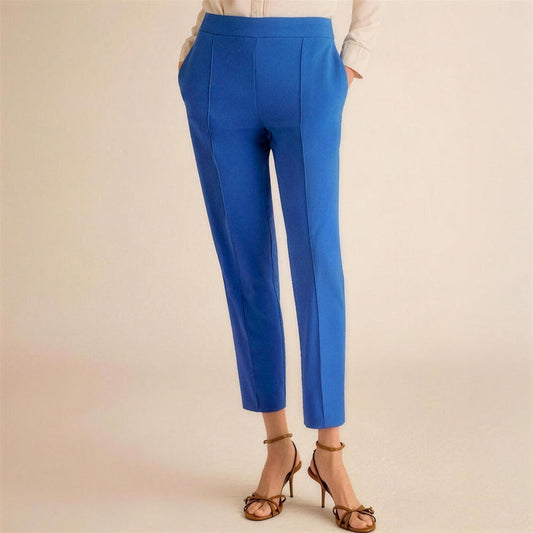 Blue pants worn by a person on a beige background | Lead