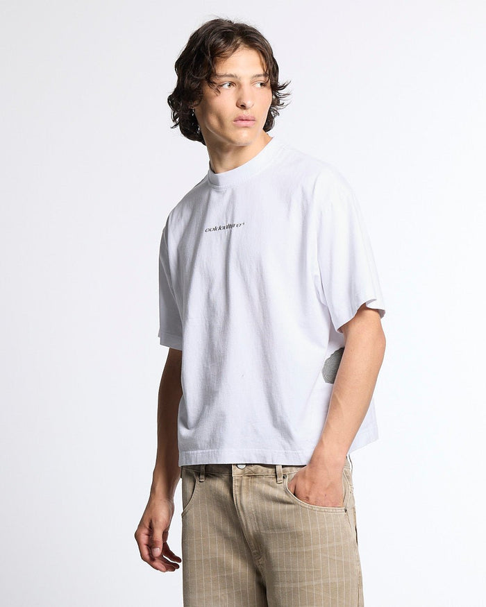 DISTRESS DEFENSE TEE WHITE - white graphic print tee, front view on male model - Cold Culture