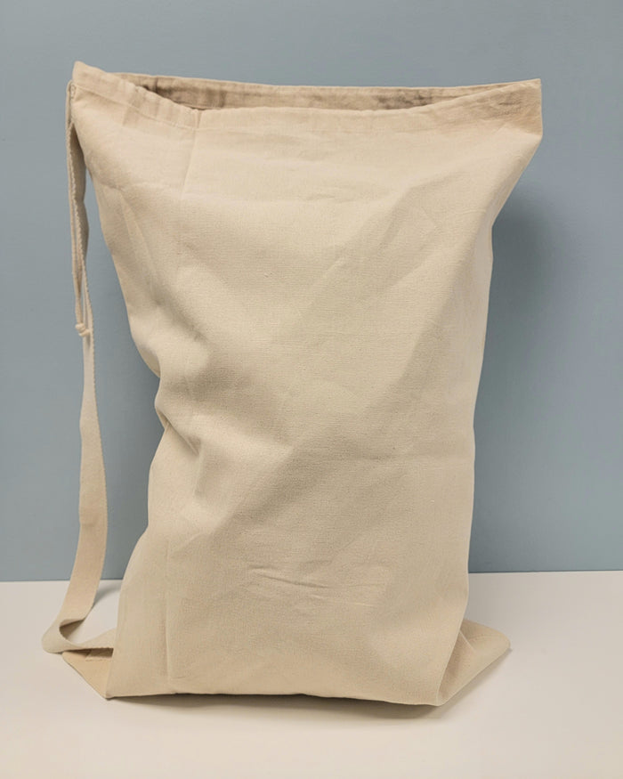 Canvas laundry bag with strap.
