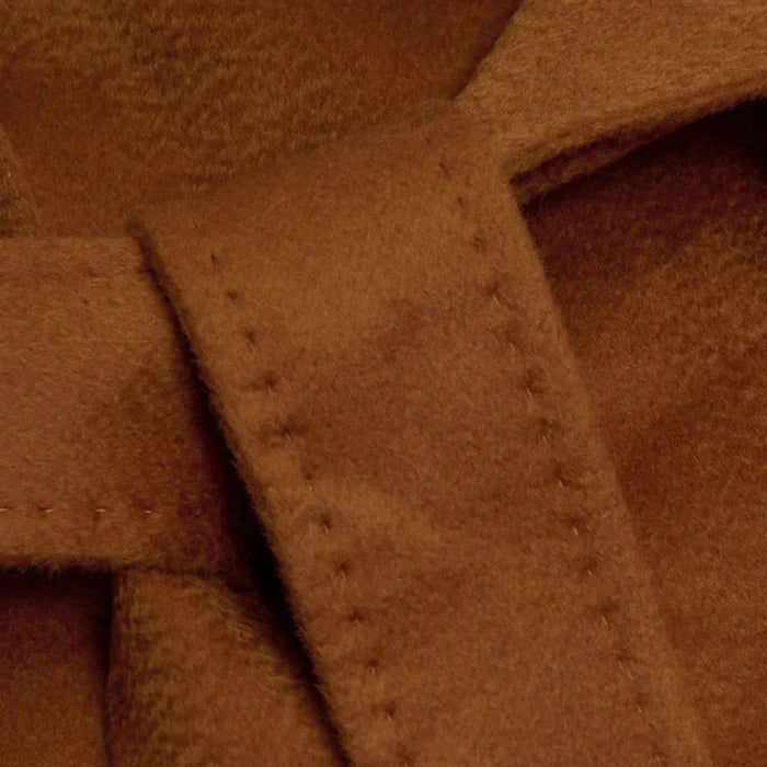 Close-up of brown coat with stitching detail
