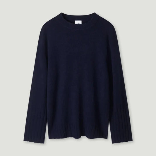 Navy blue sweater on a light gray background | Lead