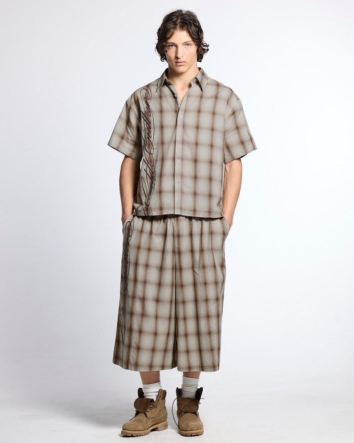 OFFICE SCRIPT SHORTS BEIGE - beige plaid wide leg shorts, front view on male model - Cold Culture