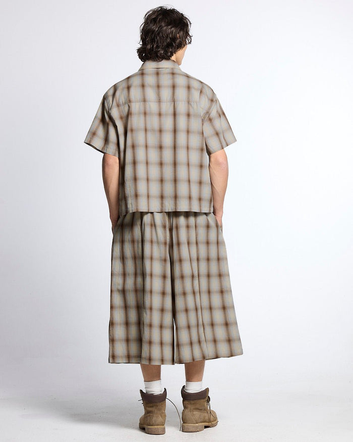 OFFICE SCRIPT SHORTS BEIGE - beige plaid wide leg shorts, back view on male model - Cold Culture