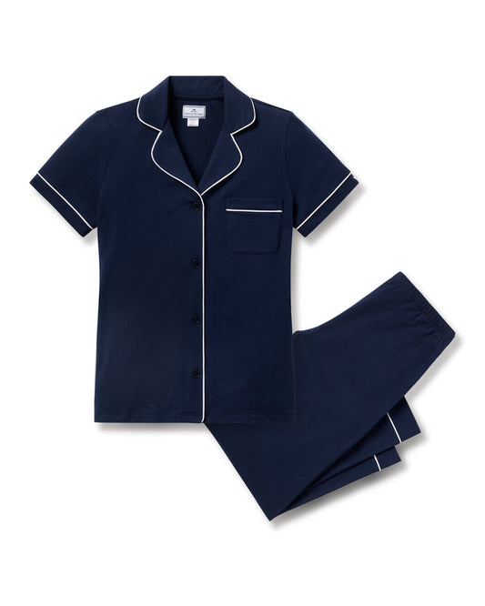 Navy blue pajama set with white piping on a white background | Lead