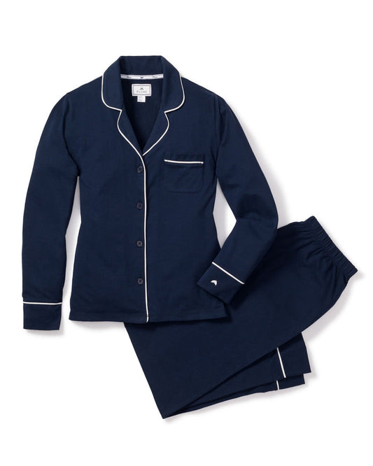 Navy blue pajama set with white piping on a white background | Lead