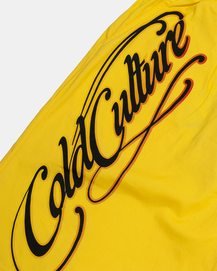 SCRIPT SWIMSHORTS YELLOW - yellow script print swim shorts, detail close-up - Cold Culture