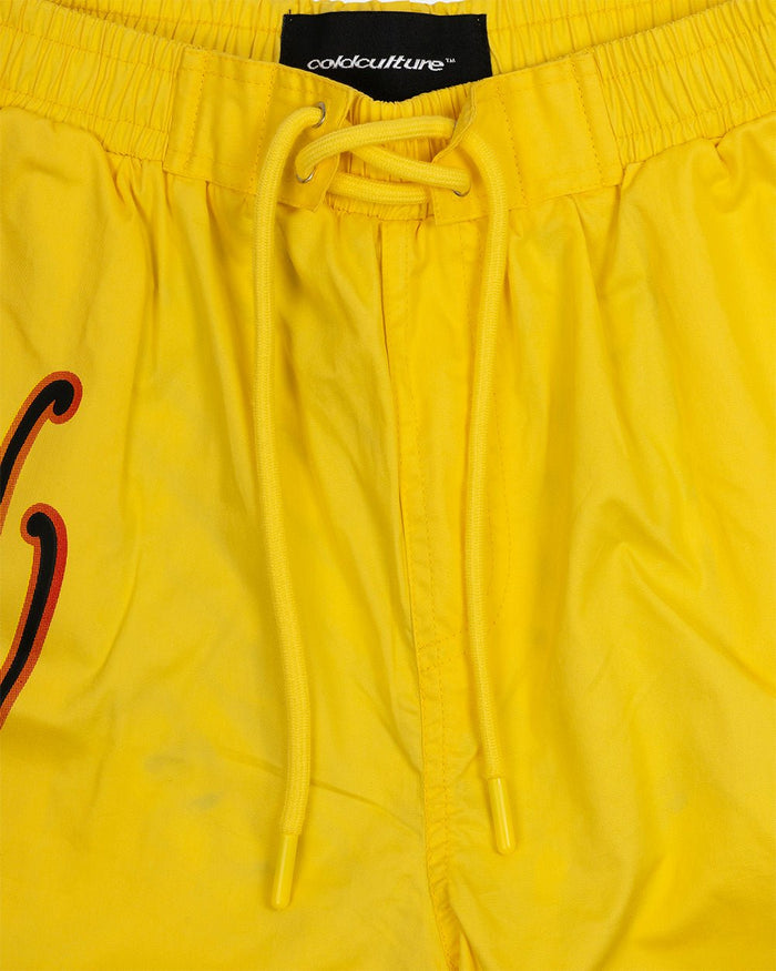 SCRIPT SWIMSHORTS YELLOW - yellow script print swim shorts, detail close-up - Cold Culture