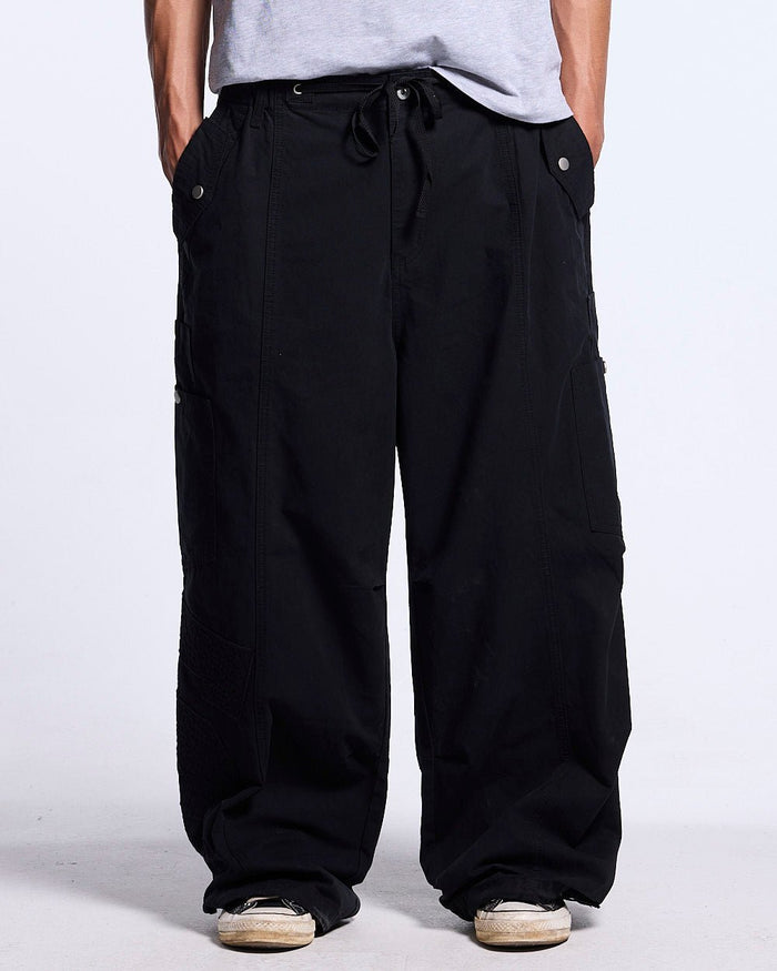 SOLID CARGO PANTS BLACK - black cargo pants, front view on male model - Cold Culture