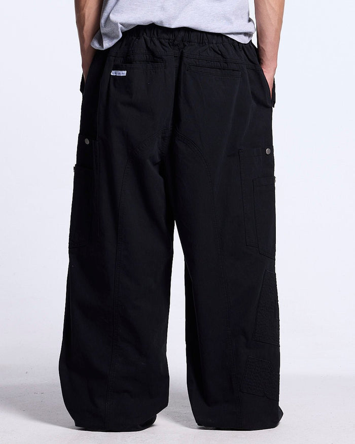 SOLID CARGO PANTS BLACK - black cargo pants, back view on male model - Cold Culture