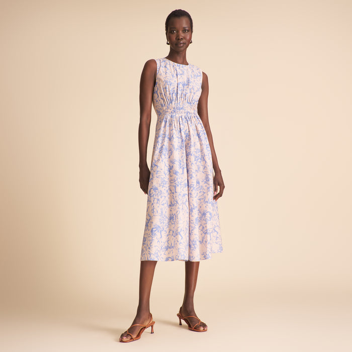 Woman wearing a floral dress on a beige background | Lead