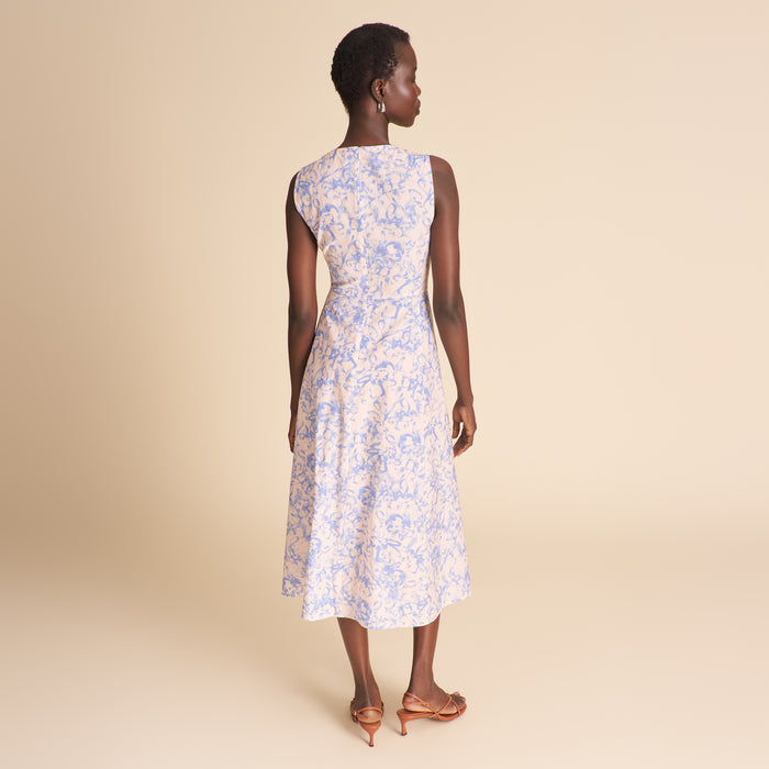 Woman wearing a floral dress on a beige background