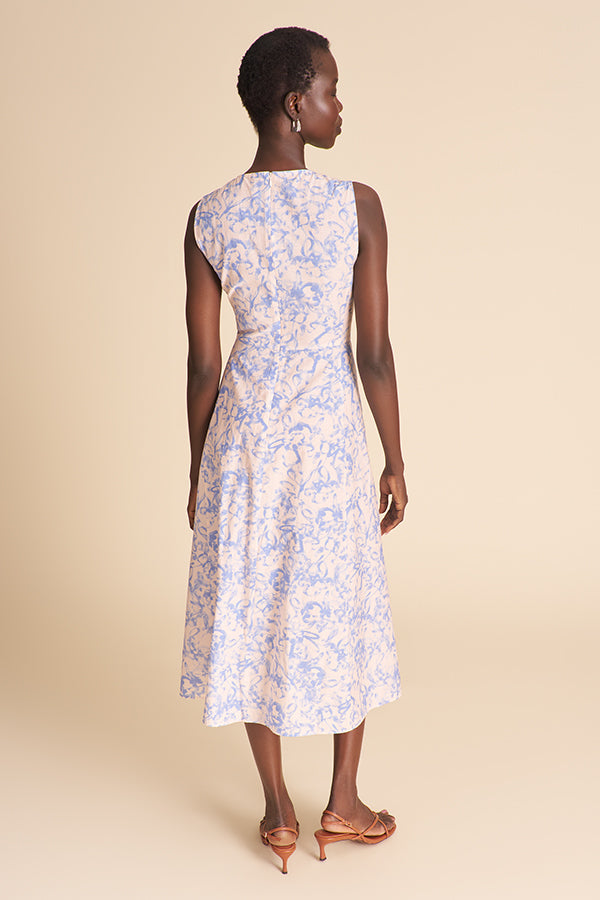 Woman wearing a floral dress on a beige background | Exclude
