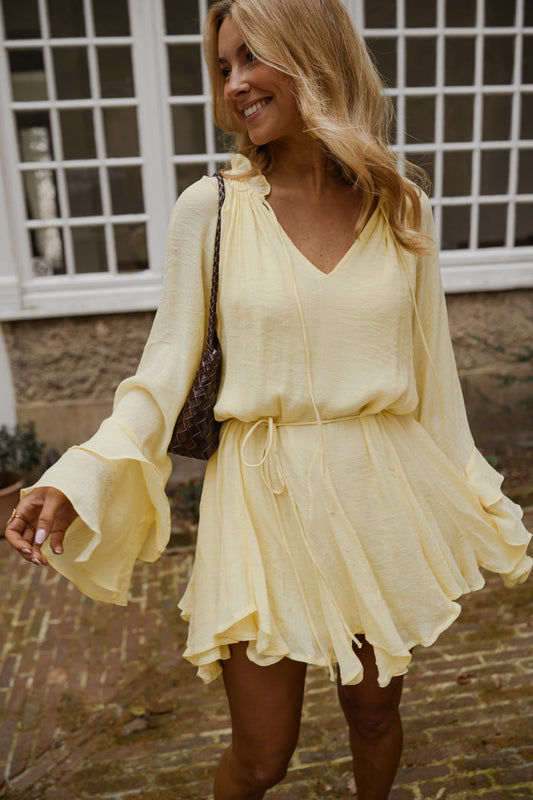 Yellow Zora Dress, flowy V-neck dress with tie collar and ruffled hem, front view