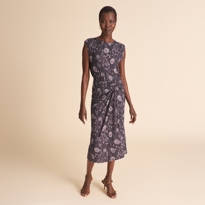 Woman wearing a floral dress on a beige background | Lead