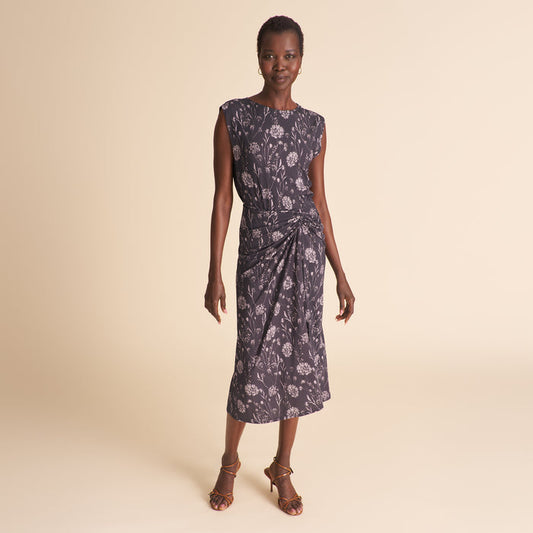 Woman wearing a floral dress on a beige background | Lead