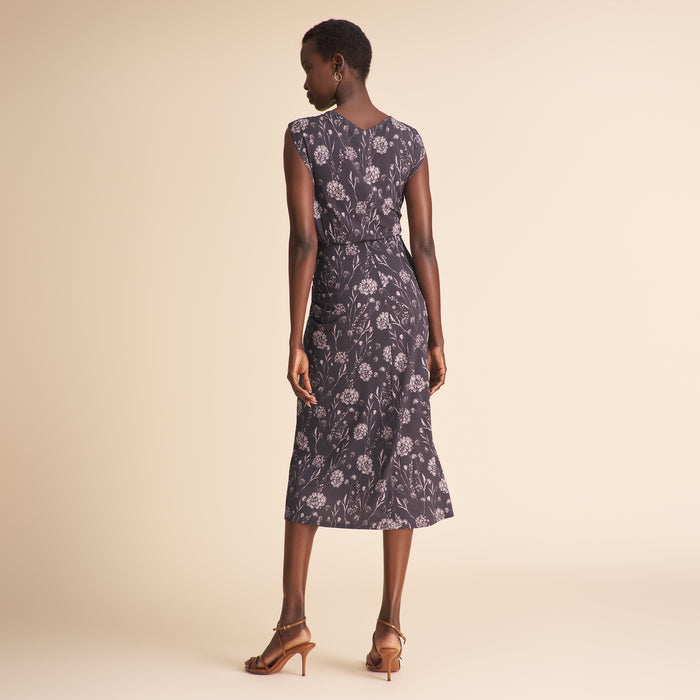 Woman wearing a floral dress on a beige background