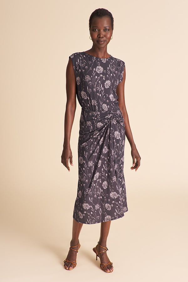 Woman wearing a floral dress on a beige background | Exclude | Grid