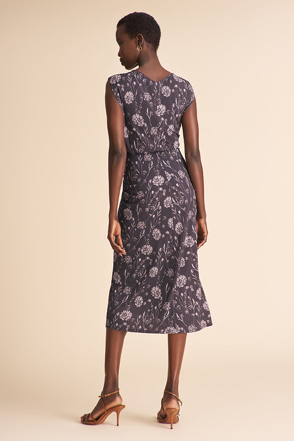 Woman wearing a floral dress on a beige background | Exclude